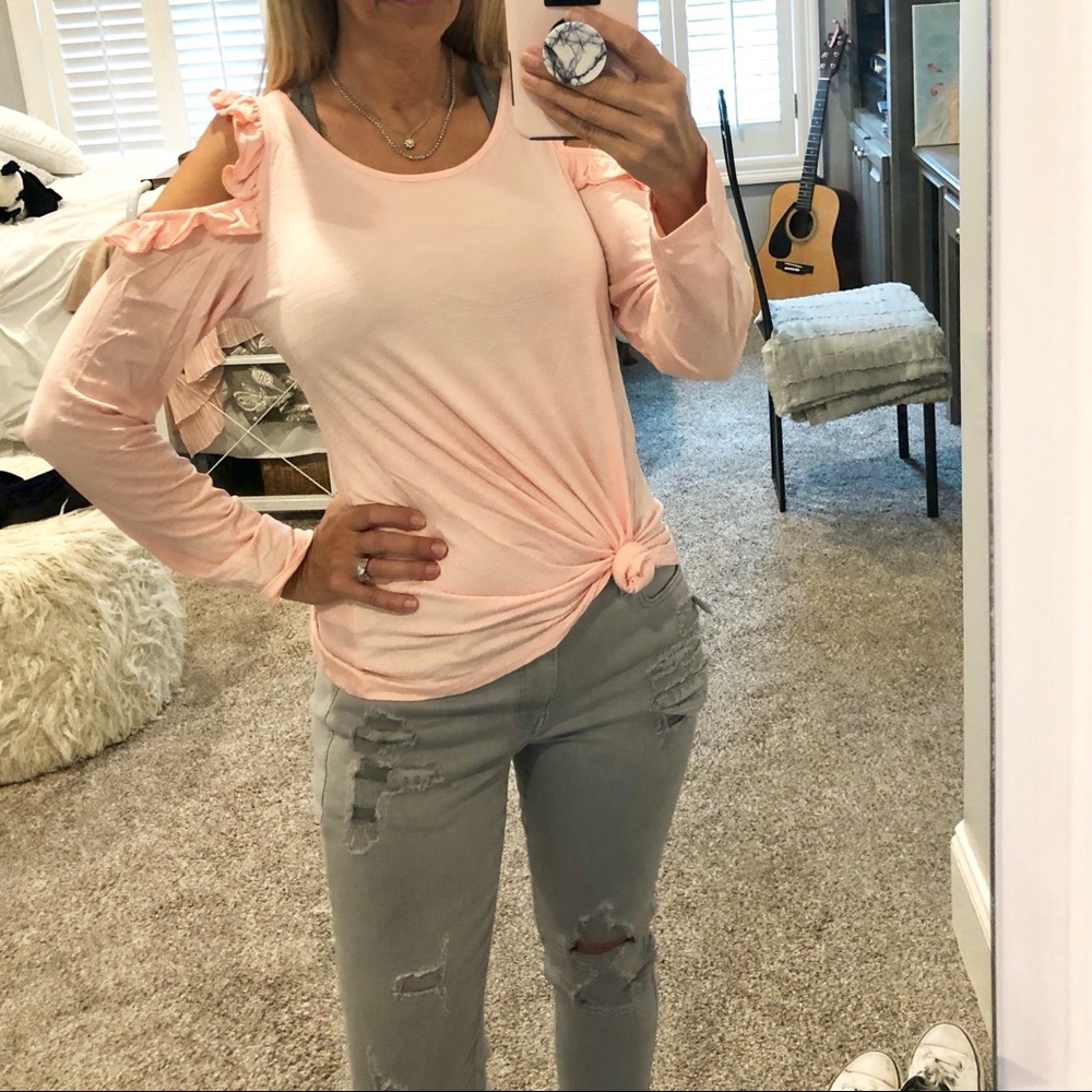 Pink top w/ ruffled cold shoulder.